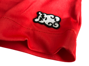 This is a photo of the black and white SleeperBear logo on the red Primrose athleisure shorts