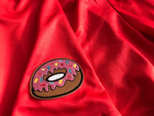 Load image into Gallery viewer, This is a photo of the donut patch on the red Primrose athleisure shorts by SleeperBear
